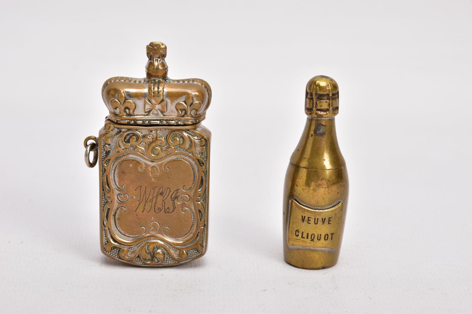 TWO BRASS VESTA CASES, the first in the form of a 'Veuve Cliquot' champagne bottle, hinged at the