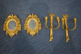 A PAIR OF GILT METAL OVAL BEVELLED EDGE WALL MIRRORS, with eagle pediment, along with a pair of gilt