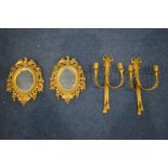 A PAIR OF GILT METAL OVAL BEVELLED EDGE WALL MIRRORS, with eagle pediment, along with a pair of gilt