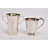 TWO EARLY 20TH CENTURY CHRISTENING CUPS, the first of plain tapered form, the top handle terminal