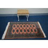 A PINK TEKKE RUG, 136cm x 79cm and a dressing stool (2)