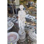 A MODERN COMPOSITE GARDEN FIGURE of a Grecian lady on top of a cylindrical base total height 126cm