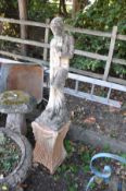 A LARGE COMPOSITE GARDEN FIGURE OF A SEMI CLAD LADY on an earlier cast iron base with fluted and