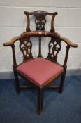 A GEORGIAN MAHOGANY CHIPPENDALE STYLE CORNER CHAIR, with a raised back, drop in seat pad, on