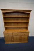 A PINE DRESSER, with three drawers, width 153cm x depth 53cm x height 200cm x height of base 84cm