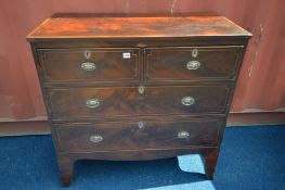 A GEORGIAN MAHOGANY AND HERRINGBONE CROSSBANDED CHEST OF TWO SHORT OVER TWO LONG DRAWERS, on high