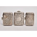 THREE SILVER VESTAS, the first with an engine turned design and floral detailing, engraved