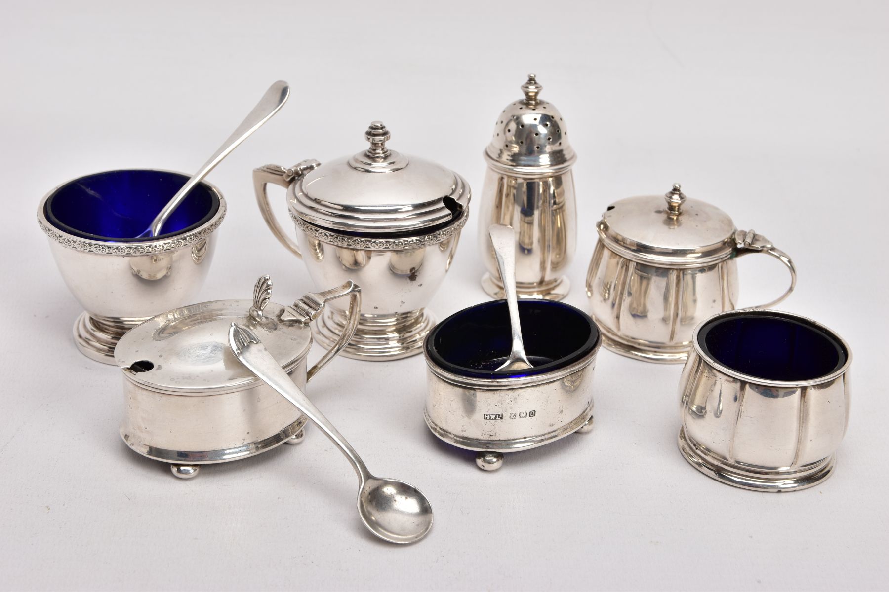 A SELECTION OF SILVER SALTS AND MUSTARDS, to include three two-piece salt and mustard sets, the