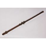 AN 18TH CENTURY GNARLED WOOD, INLAID PIN WORK AND PAINTED WALKING CANE, the smoothed top bearing