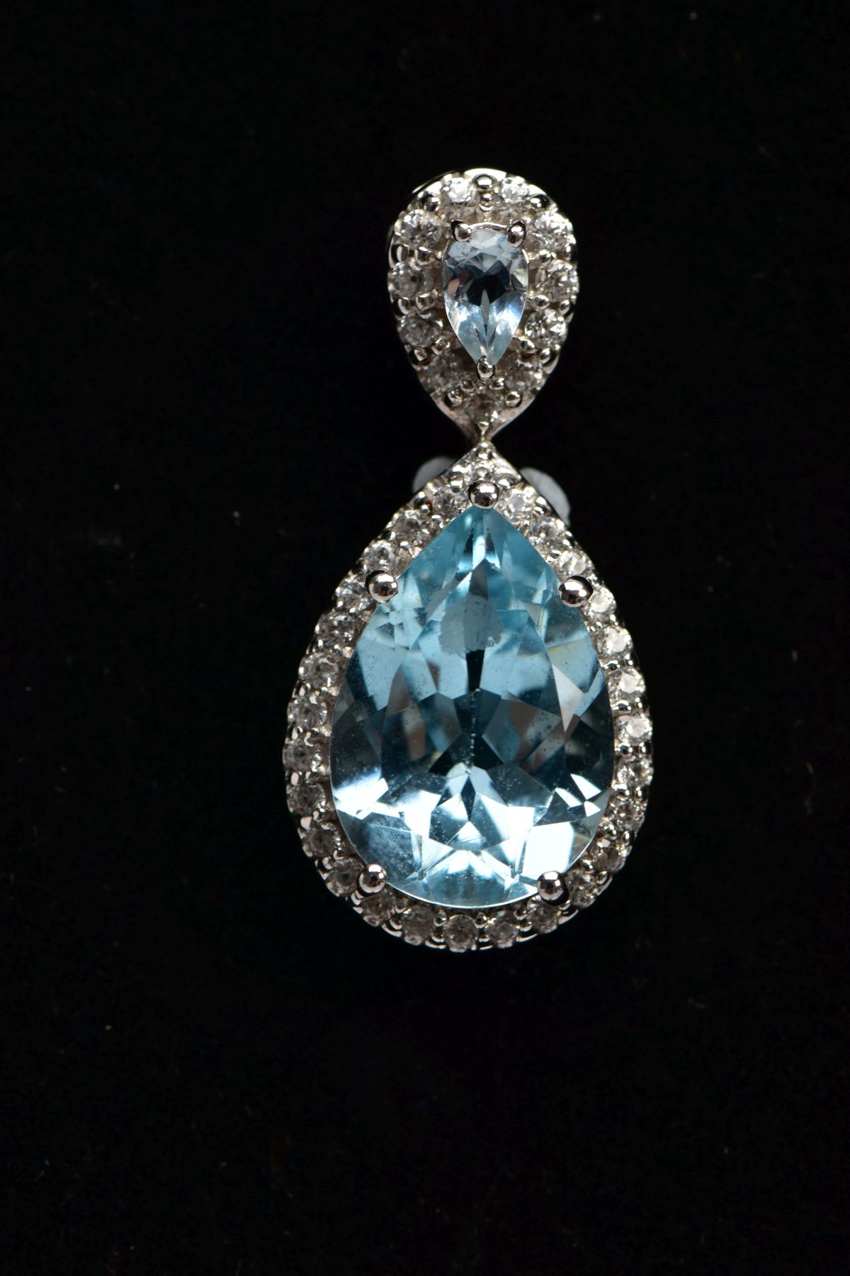 A 9CT WHITE GOLD, BLUE TOPAZ AND SPINEL PENDANT, designed with a pear cut blue topaz, within a - Image 2 of 3