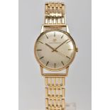 A 9CT GOLD GIRARD PERREGAUX WRISTWATCH, the circular face with gold coloured baton markers and