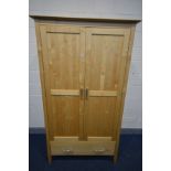 A MODERN MAPLE TWO DOOR WARDROBE, with two drawers, width 110cm x depth 64cm x height 191cm