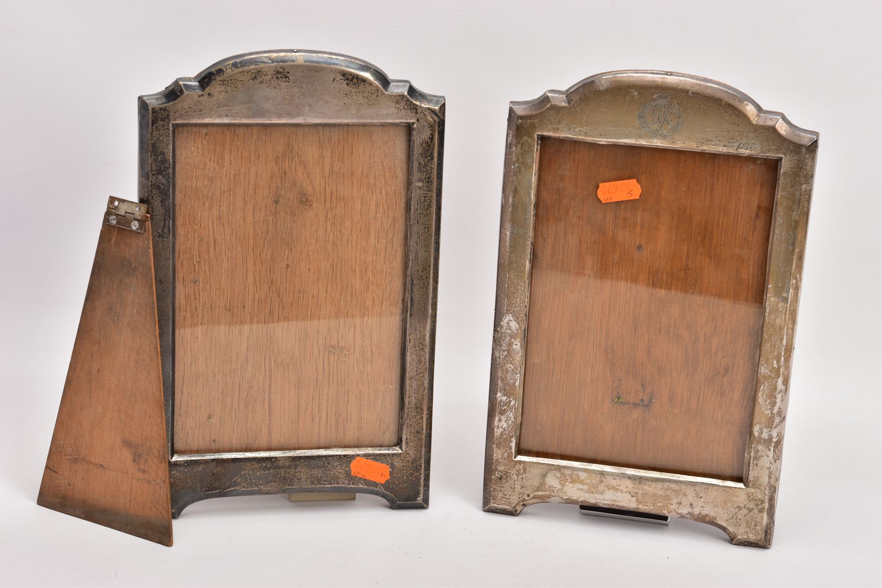 TWO EARLY 20TH CENTURY SILVER PHOTOGRAPH FRAMES, both of a similar design with arched top, one