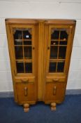A 1940'S OAK GLAZED TWO DOOR BOOKCASE, above two drawers and double cupboard doors, width 92cm x