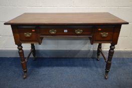 AN EDWARDIAN WALNUT SIDE TABLE, with two deep drawers flanking one drawer, on turned legs, and