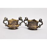 A PAIR OF LATE VICTORIAN SILVER GILT SALT CELLARS, each of an oval form, embossed floral and