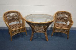 A WICKER CIRCULAR GLASS TOP CONSERVATORY TABLE, diameter 98cm x height 77cm and two armchairs (no
