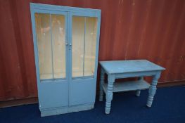 A BLUE PAINTED GLAZED TWO DOOR BOOKCASE, width 91cm x depth 28cm x height 169cm (rotten base)