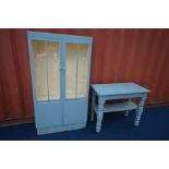 A BLUE PAINTED GLAZED TWO DOOR BOOKCASE, width 91cm x depth 28cm x height 169cm (rotten base)