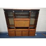 A 3 PIECE WALL UNIT, with smoked glass doors and various shelves and cupboard doors, overall width