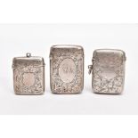 THREE LATE VICTORIAN SILVER VESTAS, each with an engraved foliate design, two with engraved