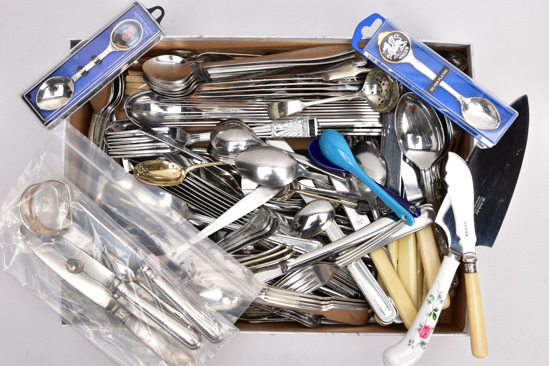 A BOX OF CUTLERY, to include a 1960's silver napkin ring, an Edwardian silver condiment spoon, a