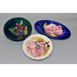 THREE PIECES OF MOORCROFT POTTERY, comprising an oval ashtray, the blue ground with pink magnolia,