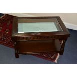 A JAYCEE RECTANGULAR OAK COFFEE TABLE, with a glass bevelled insert revealing the interior of the