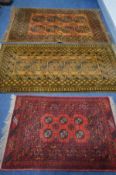 THREE VARIOUS 20TH CENTURY RUGS, to include a two russet Afghan rugs, 195cm x 129cm and 195cm x