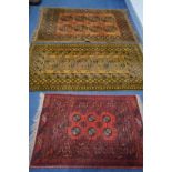 THREE VARIOUS 20TH CENTURY RUGS, to include a two russet Afghan rugs, 195cm x 129cm and 195cm x