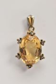 A YELLOW METAL CITRINE AND SEED PEARL PENDANT, designed with a large claw set, oval cut citrine,