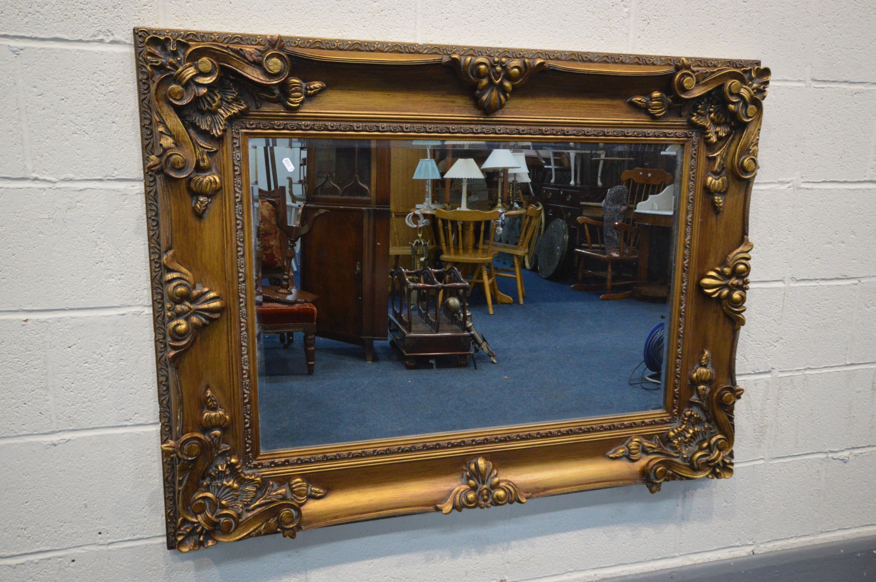 A FOLIATE GILT ON RESIN BEVELLED EDGE WALL MIRROR, 126cm x 96cm (condition - some minor chips to