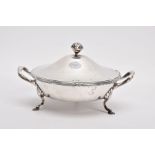 A SILVER AND GLASS CONDIMENT DISH, round form fitted with double handles, raised on three hoof feet,