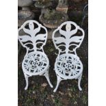 A PAIR OF MODERN WHITE PAINTED CAST IRON GARDEN CHAIRS, with pierced decoration