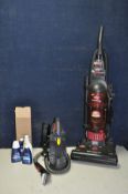 A BISSELL POWERFORCE PET UPRIGHT VACUUM and a Bissell Spot Clean Pro Heat handheld carpet cleaner