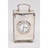 A 1920'S SILVER CASED CARRIGE CLOCK, of rectangular outline with wavy line border to the front, a