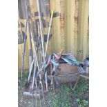 A QUANTITY OF GARDEN TOOLS to include shovels, forks etc and a wheelbarrow (20+)