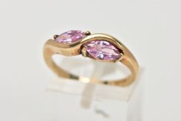 A 9CT GOLD CUBIC ZIRCONIA DRESS RING, of a crossover design, set with two marquise cut pink cubic