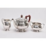 A 1930'S THREE PIECE SILVER TEA SERVICE, comprising a tea pot, milk jug and sugar bowl, each with