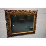 A 19TH CENTURY GILTWOOD WALL MIRROR, with open foliate scrolls, frame 97cm x 82cm, mirror 70cm x