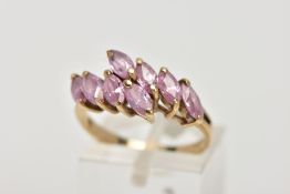 A 9CT GOLD, PINK CUBIC ZIRCONIA CROSSOVER RING, crossover style ring, set with eight marquise cut