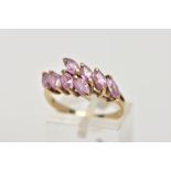 A 9CT GOLD, PINK CUBIC ZIRCONIA CROSSOVER RING, crossover style ring, set with eight marquise cut