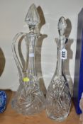 A 20TH CENTURY CLEAR CUT GLASS CLARET JUG AND A SIMILAR DECANTER, the claret jug with a facet cut