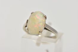 A WHITE METAL OPAL RING, designed with a four-claw set, oval opal cabochon, plain polished shank,