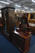 AN EDWARDIAN MAHOGANY AND BURR WALNUT PANELLED SINGLE MIRROR DOOR WARDROBE above a single drawer,