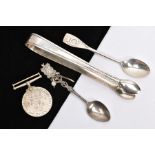 A PAIR OF SILVER SUGAR TONGS, TWO TEASPOONS AND A WWII MEDAL, a pair of Georgian reeded design sugar