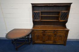 A REPRODUCTION OAK OLD CHARM STYLE DRESSER, two lead glazed cupboard doors flanking two shelves, the