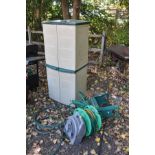 A PLASTIC GARDEN CUPBOARD with four doors width 66cm x depth 49cm x height 152cm along with two hose