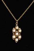 A 9CT GOLD SEED PEARL PENDANT NECKLACE, the pendant set with seven cultured seed pearls, within an