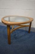 A NATHAN TEAK TRIANGULAR COFFEE TABLE, with a circular glass insert, width 77cm x height 44cm